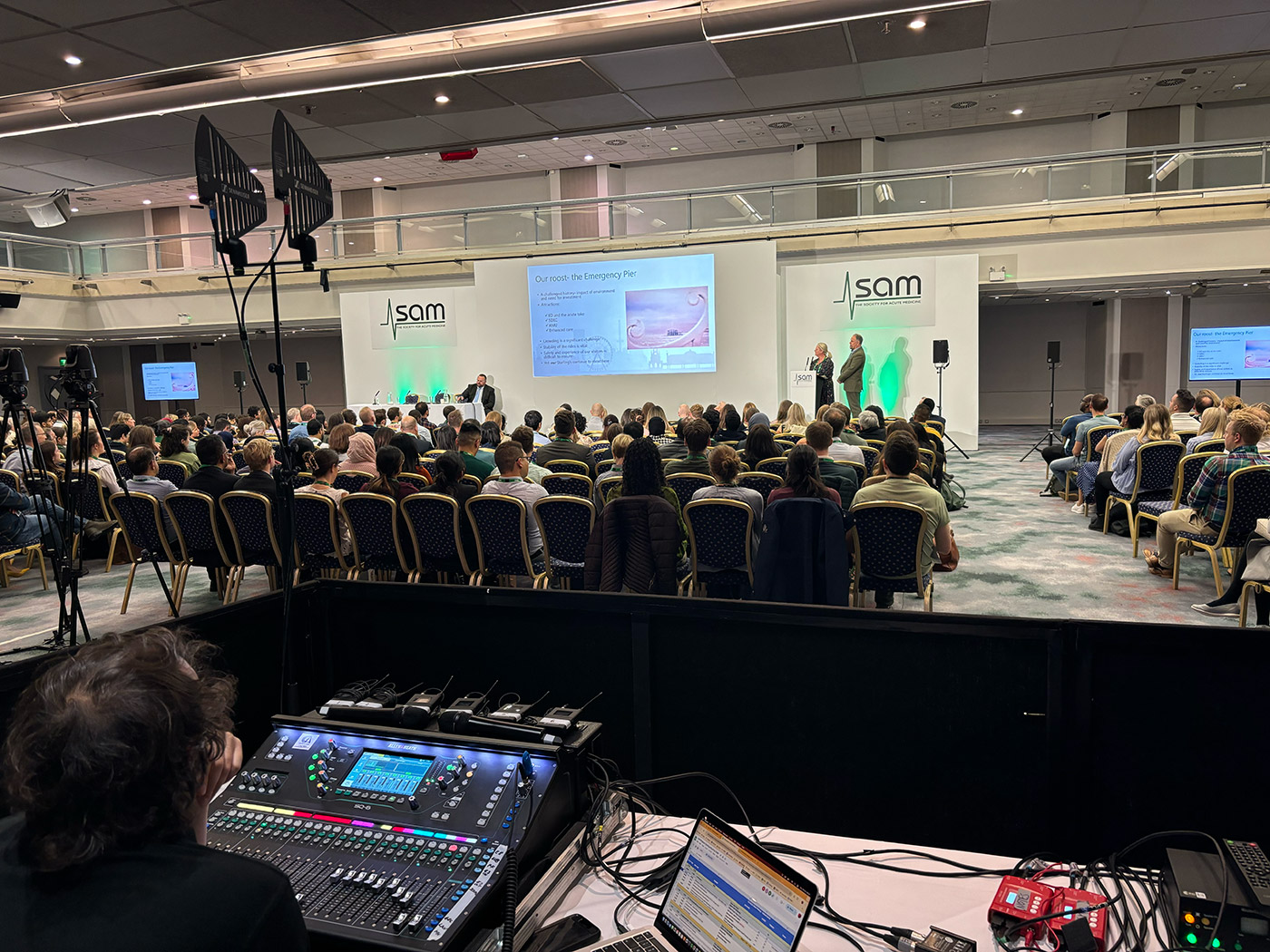 Audience watching people present on stage