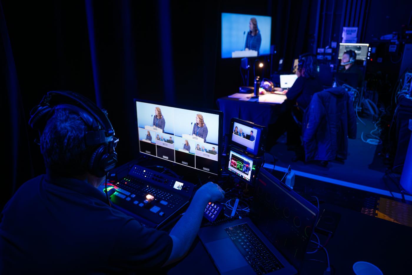 An event production technician sat at a desk, controlling the graphics and video happening on stage.