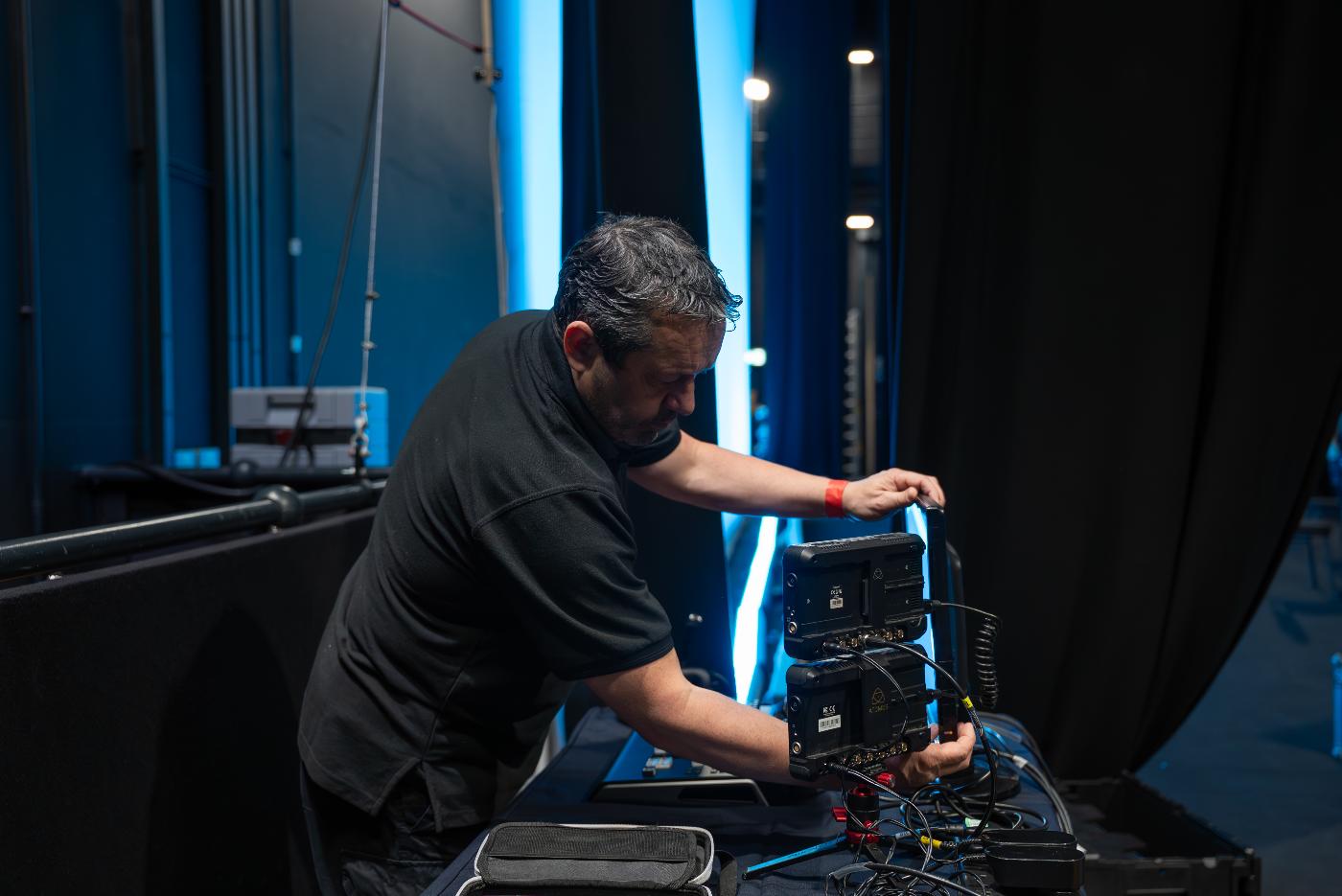 An event technician setting up equipment.