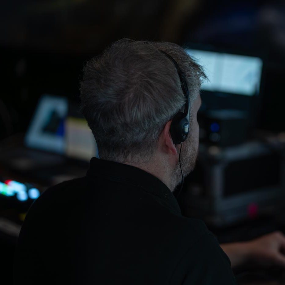 A CPG event technician, working at a computer.
