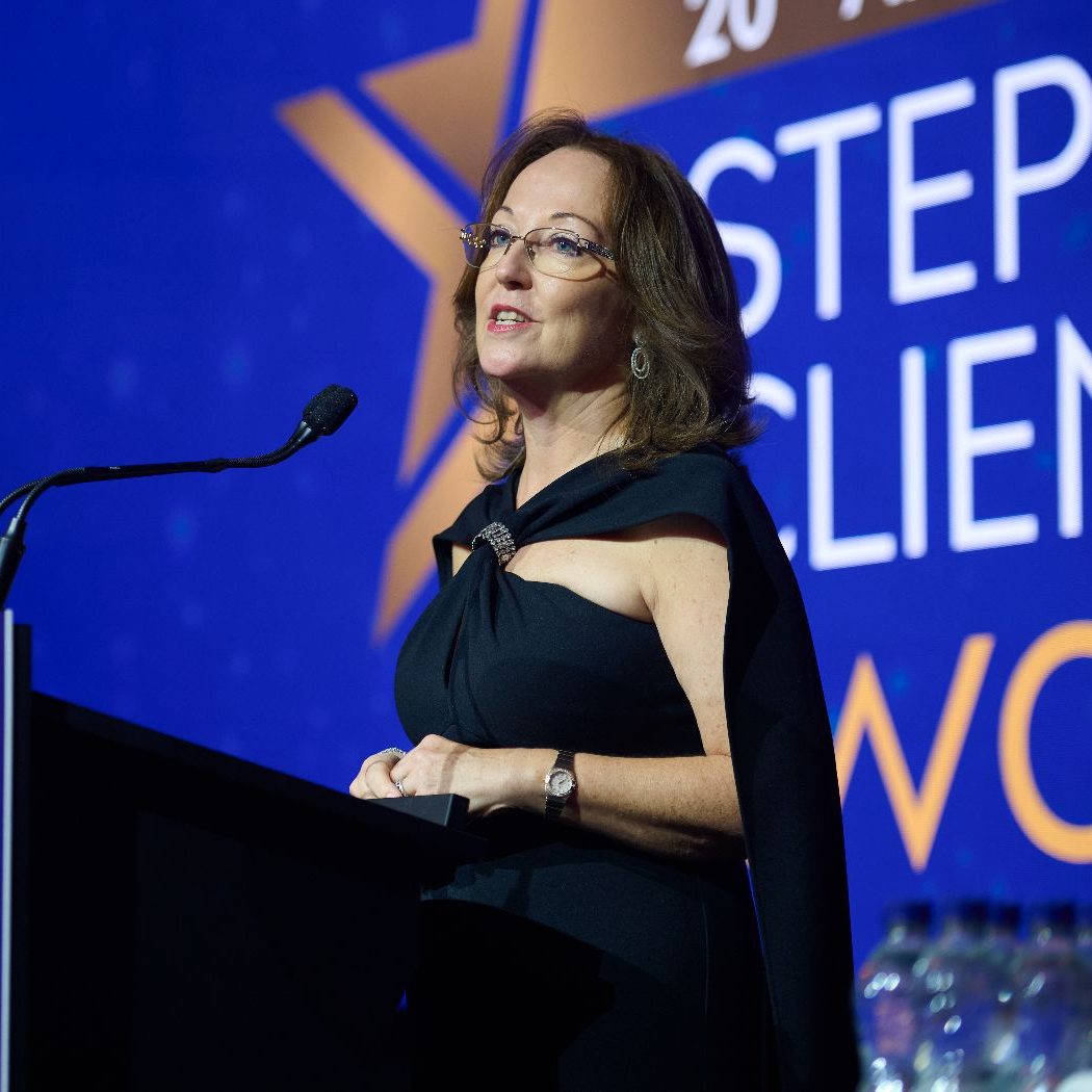 A woman presenting at a podium, at the STEP private client awards