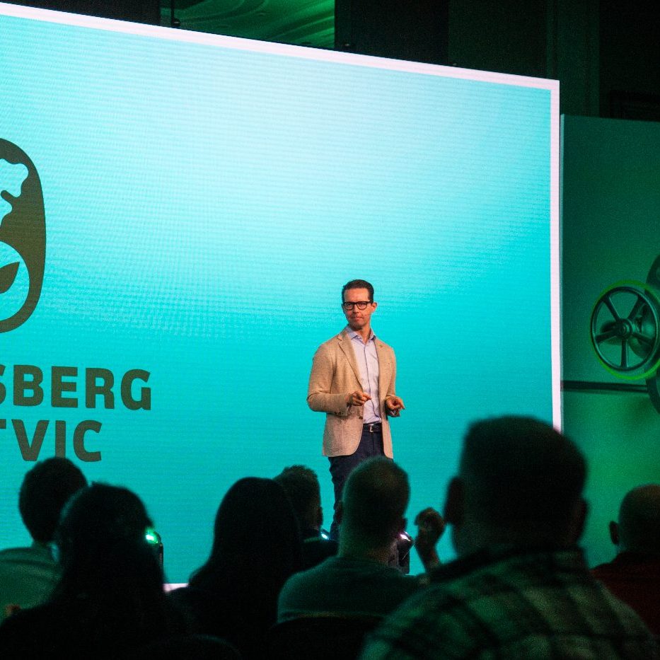 A man presenting on stage at the carlsberg britvic event