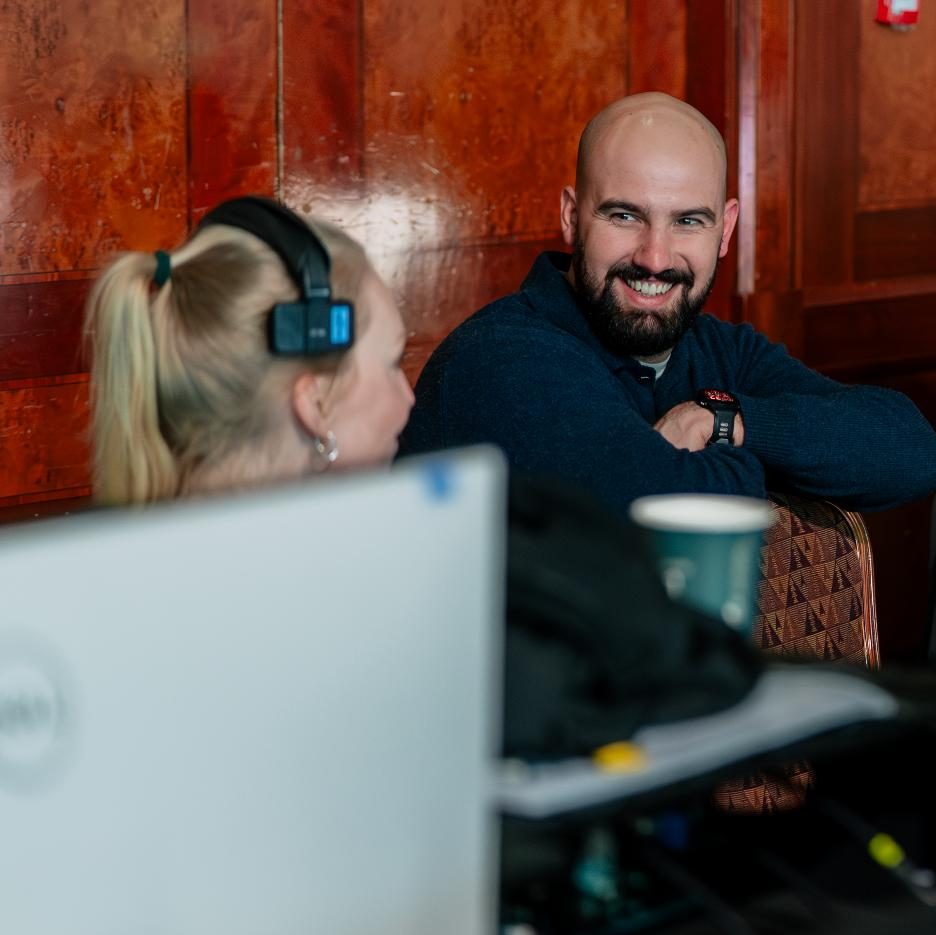 An event production manager smiling at his team