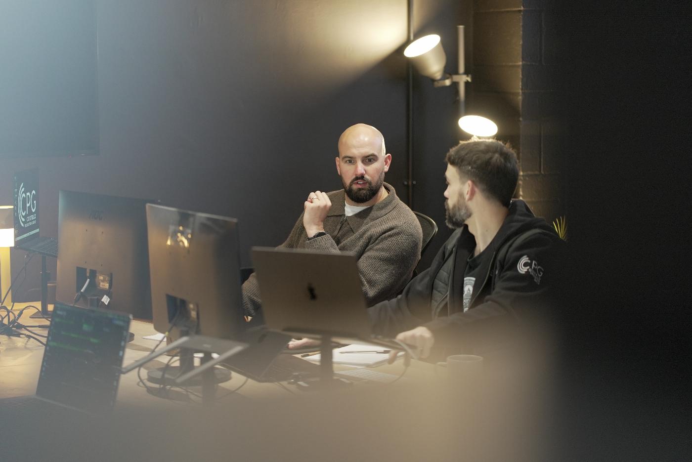 Two event production professionals discussing their work